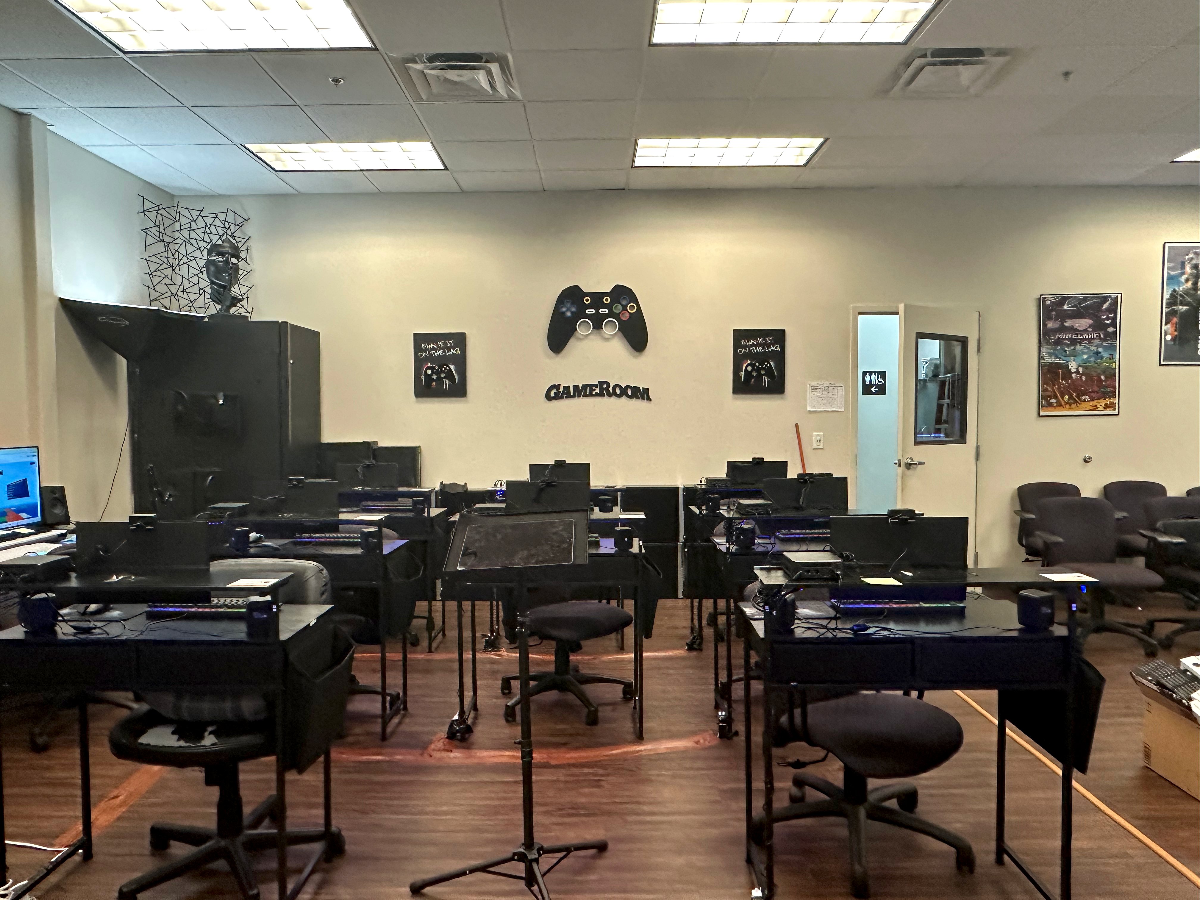 Game room with GAMEROOM sign and gaming equipment